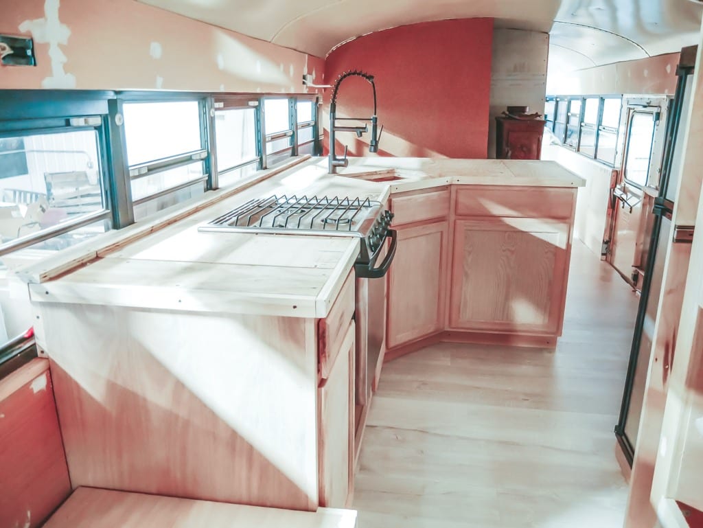 We get a lot of questions about our little skoolie kitchen! From our conrete countertops to the rose gold appliances, here are the answers! | Since We Woke Up | sincewewokeup.com