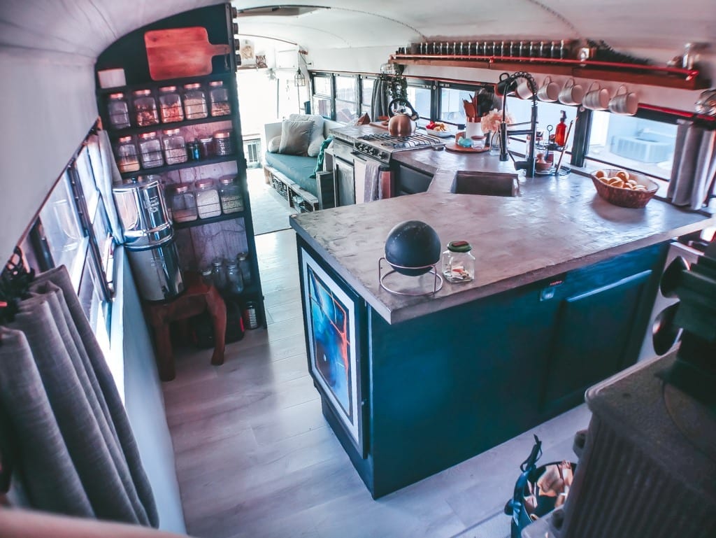 We get a lot of questions about our little skoolie kitchen! From our conrete countertops to the rose gold appliances, here are the answers! | Since We Woke Up | sincewewokeup.com
