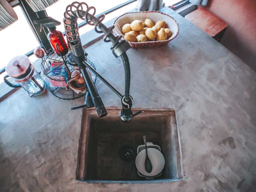 We get a lot of questions about our little skoolie kitchen! From our conrete countertops to the rose gold appliances, here are the answers! | Since We Woke Up | sincewewokeup.com